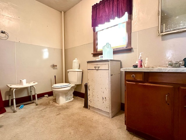 bathroom featuring toilet and vanity