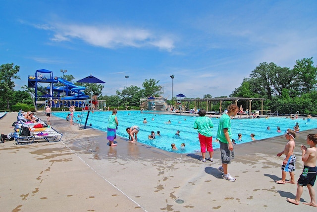 view of pool with a water play area