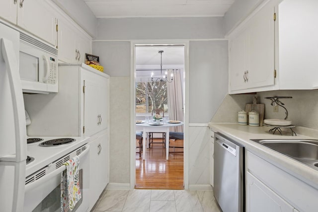 kitchen featuring white appliances, white cabinets, marble finish floor, and an inviting chandelier