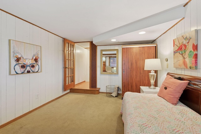 carpeted bedroom featuring ornamental molding and baseboards