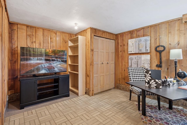 office featuring brick floor and wooden walls