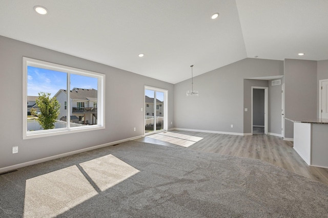 interior space with lofted ceiling, light carpet, and a notable chandelier