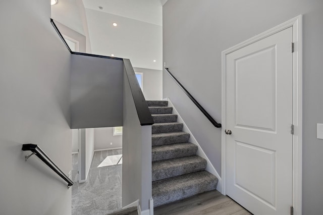 stairway with hardwood / wood-style floors