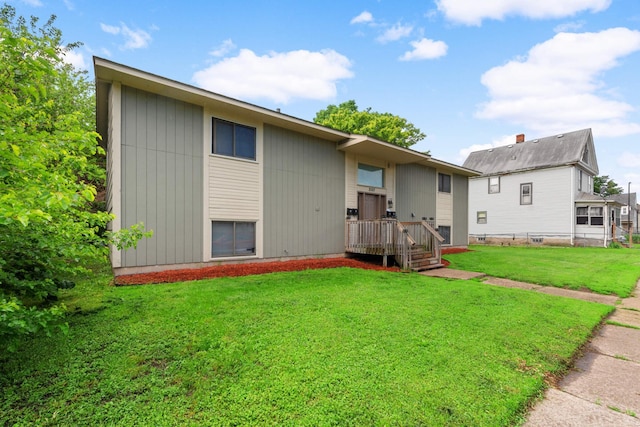 rear view of property with a yard