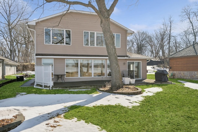 rear view of property with central AC and a yard