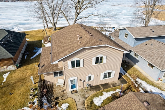 exterior space featuring a patio area and roof with shingles