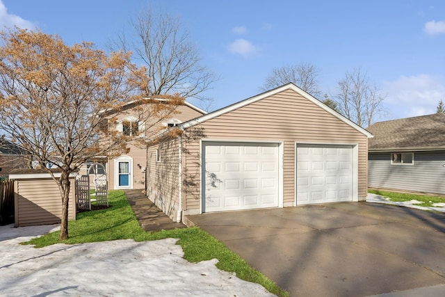 view of front facade featuring a garage and an outdoor structure