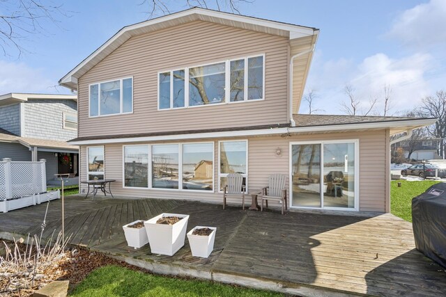 rear view of property featuring a deck