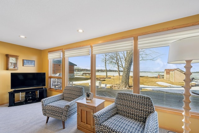 sitting room featuring recessed lighting, carpet, and a healthy amount of sunlight