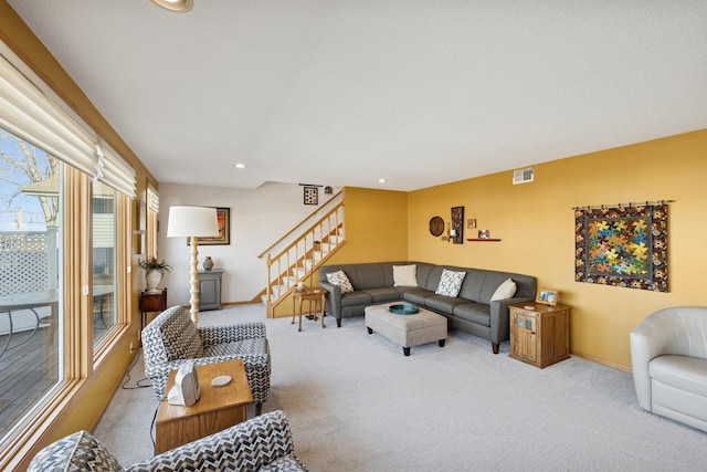 living room featuring baseboards, visible vents, stairs, carpet floors, and recessed lighting