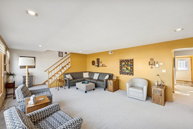 carpeted living area featuring stairway and recessed lighting