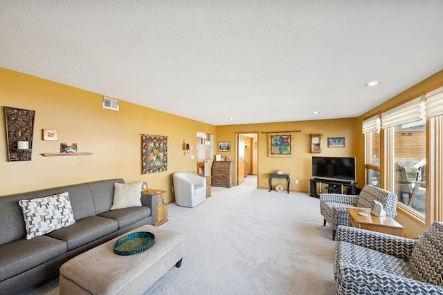 living room with a textured ceiling, visible vents, carpet flooring, and recessed lighting