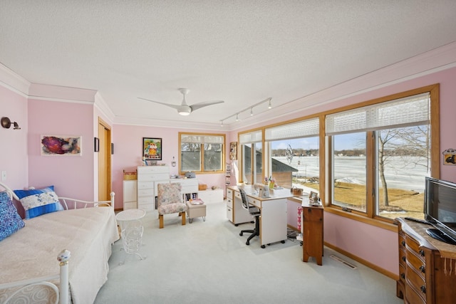 office with crown molding, a ceiling fan, carpet flooring, a textured ceiling, and baseboards