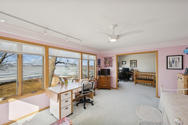 home office with ceiling fan, a textured ceiling, light carpet, visible vents, and ornamental molding