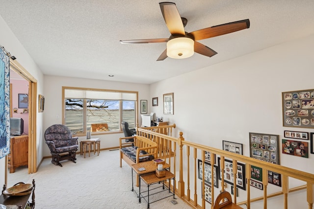 home office featuring a ceiling fan, a textured ceiling, baseboards, and carpet flooring