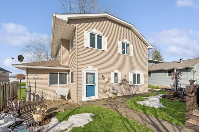 view of front of property with fence and a patio