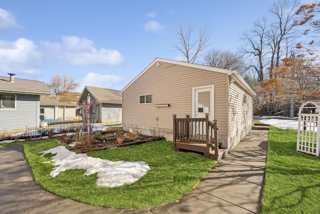 view of side of home with a yard