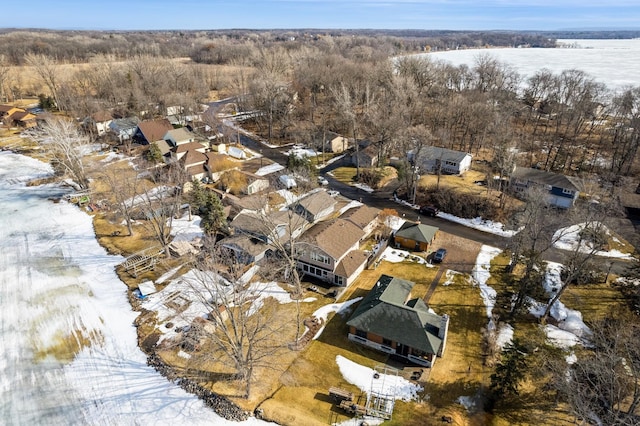 drone / aerial view featuring a residential view and a view of trees