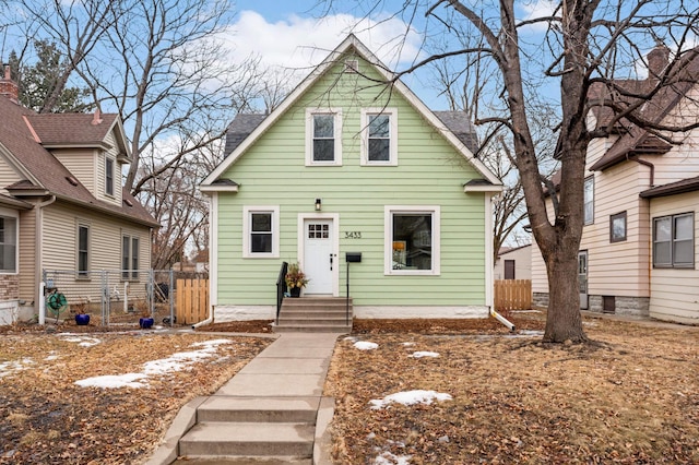 view of front of home featuring fence