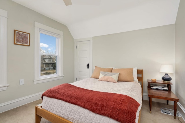 bedroom with light colored carpet, visible vents, a ceiling fan, vaulted ceiling, and baseboards