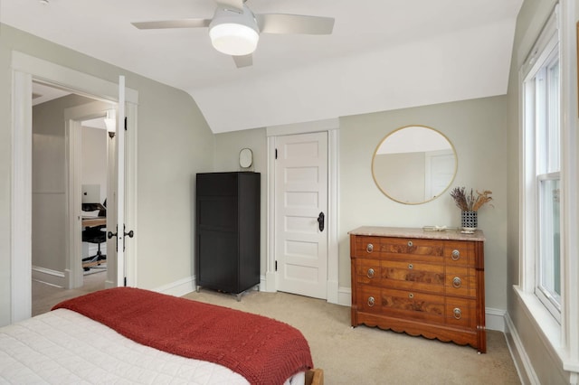 bedroom with lofted ceiling, ceiling fan, light carpet, and baseboards