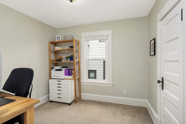 office space featuring light carpet and baseboards