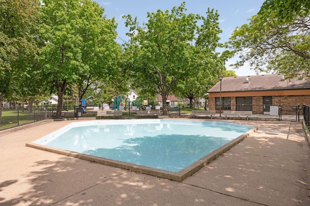 community pool featuring a patio and fence