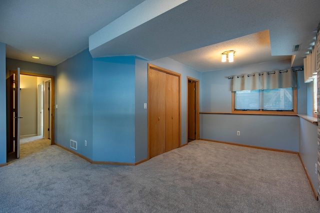 unfurnished bedroom featuring carpet floors, a closet, and baseboards