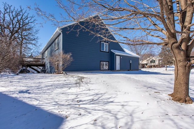 view of snow covered exterior with a deck
