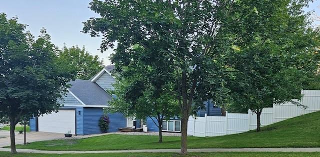 obstructed view of property with an attached garage and driveway