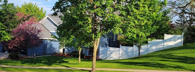 view of property exterior with a yard