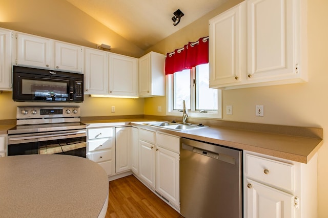 602 Cortland Ln SW, Rochester, MN 55902 - kitchen featuring appliances with stainless steel finishes, a sink, lofted ceiling, light wood-style floors, and white cabinetry