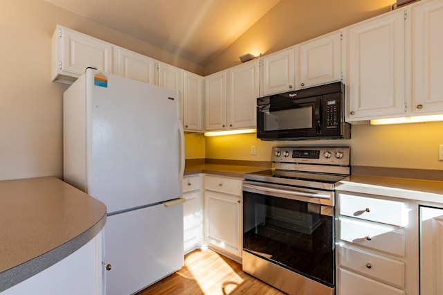 602 Cortland Ln SW, Rochester, MN 55902 - kitchen with black microwave, stainless steel range with electric stovetop, freestanding refrigerator, vaulted ceiling, and light wood finished floors