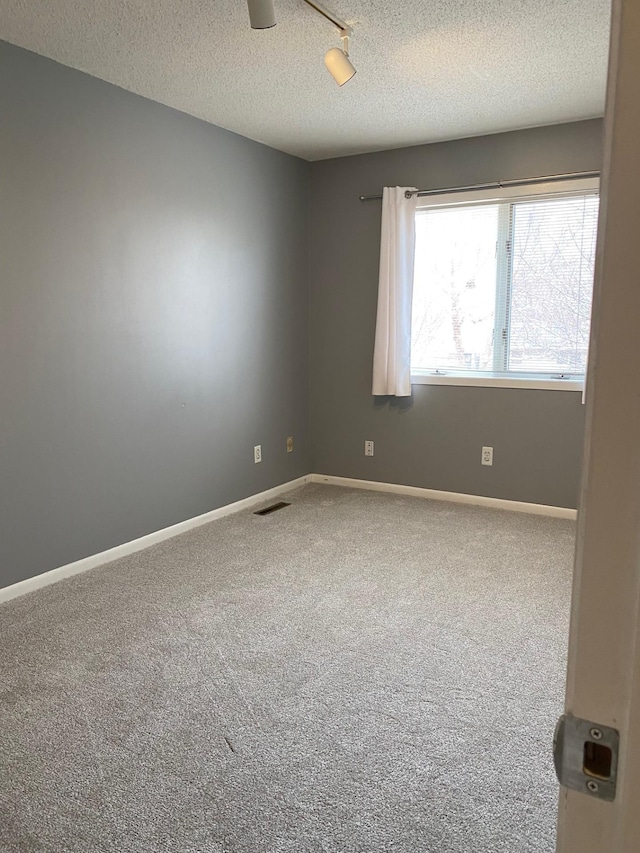 602 Cortland Ln SW, Rochester, MN 55902 - carpeted spare room featuring a textured ceiling and baseboards
