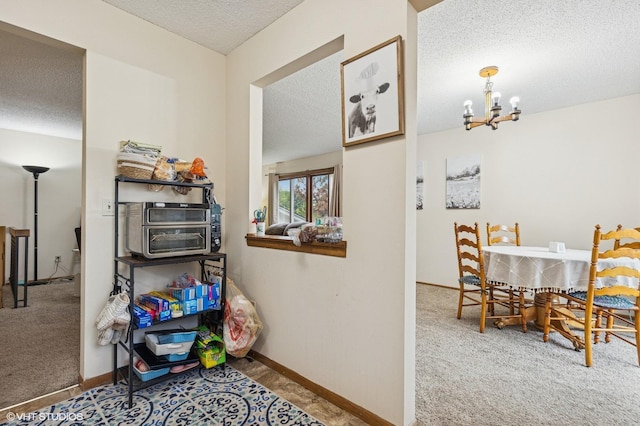 2528 Birchview Ln, Minnetonka, MN 55305 - carpeted dining area with a textured ceiling, a chandelier, and baseboards