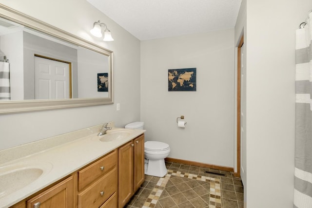 bathroom with a textured ceiling, vanity, a shower with shower curtain, and toilet