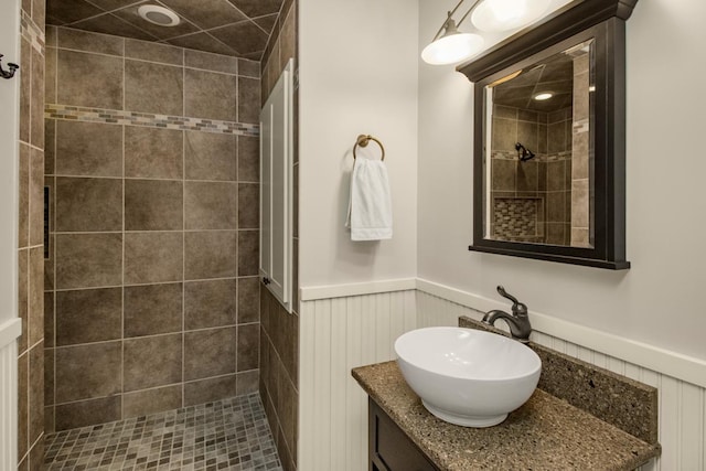 bathroom with vanity and tiled shower