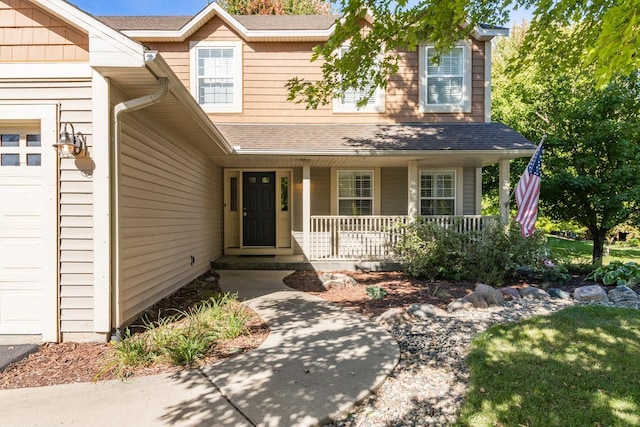 view of front facade featuring a porch and a garage