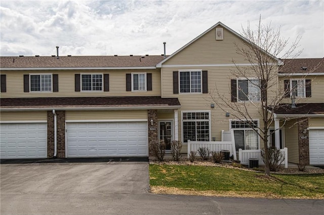 view of property with cooling unit and a garage