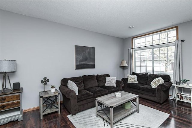 living room featuring dark hardwood / wood-style floors and a textured ceiling