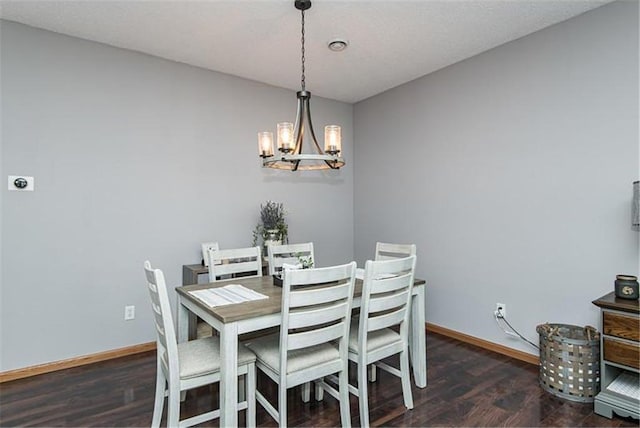 dining room featuring a chandelier and dark wood-type flooring