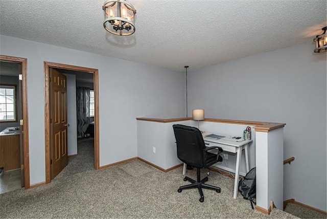 carpeted office with a textured ceiling