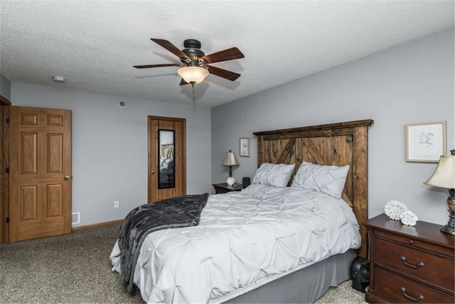 carpeted bedroom featuring a textured ceiling and ceiling fan