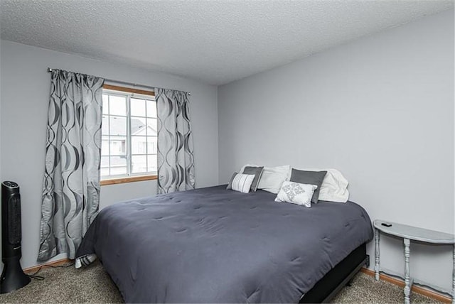 bedroom featuring carpet floors and a textured ceiling