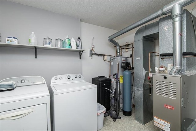 clothes washing area featuring heating unit, water heater, a textured ceiling, and washing machine and clothes dryer