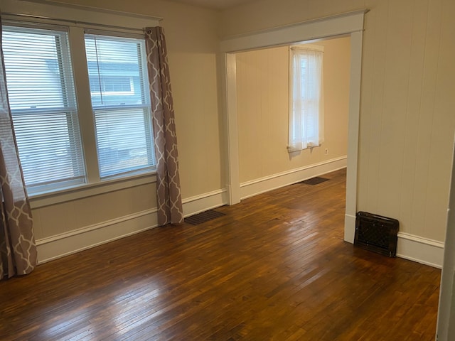 empty room with dark hardwood / wood-style floors