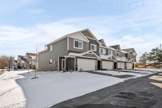 view of front of property featuring board and batten siding, a residential view, and an attached garage