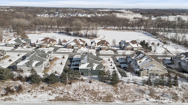 snowy aerial view with a residential view