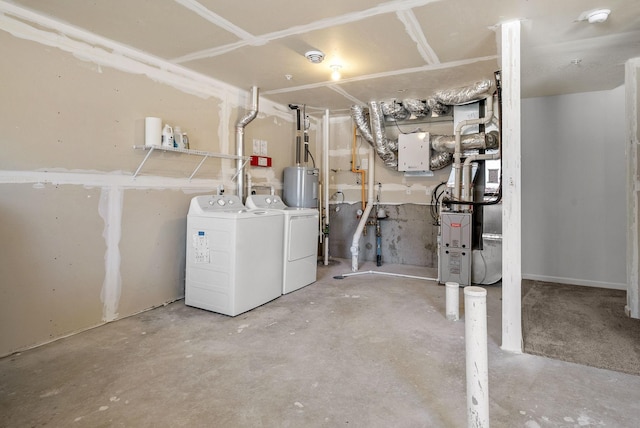 unfinished basement featuring washer and clothes dryer and electric water heater