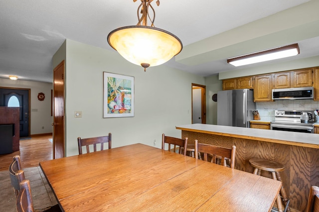 dining area with wood finished floors